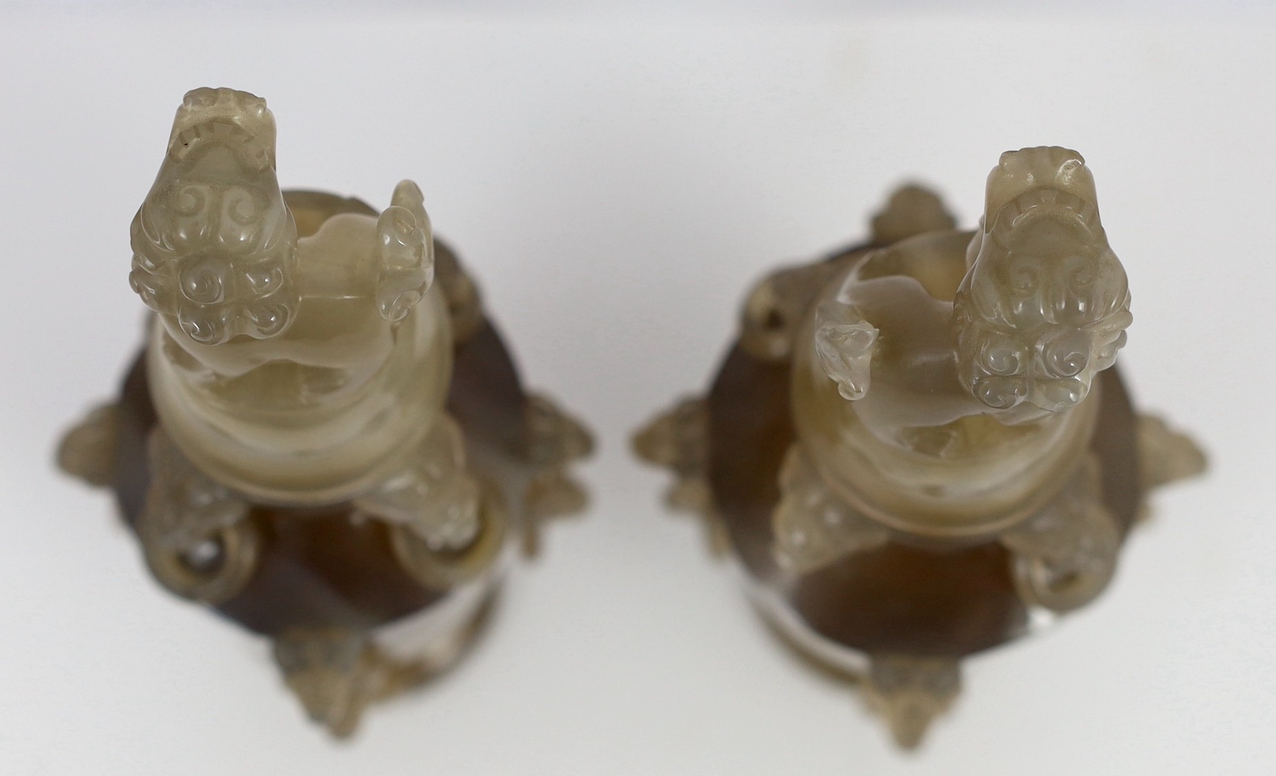 A pair of Chinese agate vases and covers, early 20th century, 19.5cm high, chip to one lion